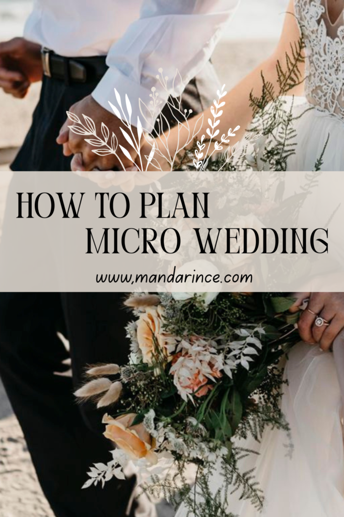 A couple holding hands on the beach, with the bride carrying a rustic bouquet of peach and white flowers, symbolizing an intimate and elegant micro wedding.